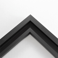 This simplistic yet modular matte black frame is designed for metal prints, acrylic prints and dry mounts. This smart design features a minimalist stepped profile that serves as a floater frame or a standard picture frame.

For the floating effect, the print can be attached on top of the inner step of the frame, without sacrificing the artwork edges.

This frame can also be used as standard picture frame. The lowered center paired with slightly raised outer lip creates a frame within a frame effect. However, due to the inner most lip of the frame, a fraction of the artwork will be hidden. But, this can be avoided with a linen liner combo.