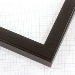 A simple 1-1/4 " wood frame with a concave top, features a smooth texture that enhances the dark black finish.