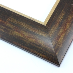 This bold, 2.5 " frame features a reverse profile design; it slopes from thickest at the inner edge to thin at the outer.  Overlapping brown, gold and deep red layers result in a faux wood-grain, rustic effect.  The cracked gold foil inner edge slants in toward the artwork. 

Best suited to large artwork; the perfect border to a rural or autumnal reproduction.