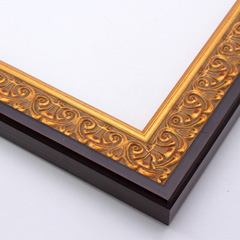 An ornate, solid wood frame featuring an intricate design overlaid with elegant gold leaf, and lightly antiqued.  A shallow scooped profile and unadorned inner edge draw the eye inward. A dark brown outer edge highlights the design.  

1.75 " width: ideal for medium-sized artworks.  Oil paintings, prints and formal family photos will be equally at home encased in this traditional frame.