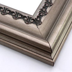 This steep, solid wood frame features a crown moulding profile in a bold, bronze-brushed silver.  The slight distressing on the deeply scooped face and the faint red patina on the delicate inner design give it an antique look that suits old paintings, prints and family photographs alike.

3.5 " width and 2 " high at outer edge: ideal for large and oversize images.
