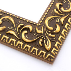 A large, reverse curve profile frame with an intricate leaf design bordered by a geometric outer edge and beaded inner lip.  A dark, matte gold-brown base with gold foil patina for added depth on the topmost points of the design. Strong, solid wood construction.

2.75 " witdth: ideal for large and oversize (extra large) images.