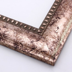 This solid wood frame features a wide clam shell profile finished with silver foil and copper/brown accents.  The result is a marbled rose-gold design that gives the frame a high fashion style.  The beaded inner lip completes the design, tipped with the same mottled colouring.

2.5 " width: ideal for medium and large images.  Border bold oil paintings or prints, or fine art photographs.