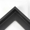 This L-shaped modern canvas floater frame, features a black smooth curved wall. 

*Note: These solid wood, custom canvas floaters are for stretched canvas prints and paintings, and raised wood panels.