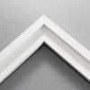This simplistic yet modular white frame is designed for metal prints, acrylic prints and dry mounts. This smart design features a minimalist stepped profile that serves as a floater frame or a standard picture frame.

For the floating effect, the print can be attached on top of the inner step of the frame, without sacrificing the artwork edges.

This frame can also be used as standard picture frame. The lowered center paired with slightly raised outer lip creates a frame within a frame effect. However, due to the inner most lip of the frame, a fraction of the artwork will be hidden. But, this can be avoided with a linen liner combo.