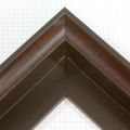 This bold 1-9/16 floater frame has a deep set bevel around the inside edge of the frame which adds depth to its contents. Overall this frame is Mahogany in color, accented by lighter streaks in a grain pattern. The inside of the bevel is stained a subtle green-grey with wood grain showing through.