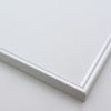 This simple metal picture frame has a smooth, frosted silver finish and curved profile. The outer drop edge has a tiny vertical ridge texture. 

.375 " width: ideal for small, medium or large artworks. Easily frame photographs, paintings or drawings on paper, or even Giclée canvas prints.