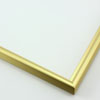 This simple metal picture frame has a smooth, frosted gold finish and curved profile. The outer drop edge has a tiny vertical ridge texture. 

.375 " width: ideal for small or medium artworks. Easily frame photographs, paintings or drawings on paper, or even Giclée canvas prints.