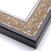 An ornate, solid wood frame featuring an intricate design overlaid with elegant silver leaf, and lightly antiqued.  A shallow scooped profile and unadorned inner edge draw the eye inward. A dark brown outer edge highlights the design.  

2.75 " width: ideal for large and oversize artworks.  Oil paintings, Giclée prints and formal family photos will be equally at home encased in this traditional frame.