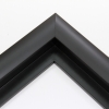 This simple, matte black frame features a thick curved profile.  The slope of the face makes this a simple but glamorous selection. A 1 " rabbet gives this frame a narrow shadow-box quality.

Ideal for medium-sized and large images.  Select an oil or watercolour painting, print, or grayscale photograph.