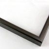 9/16 " slim, curved metal frame. This frame ranges in color from dark grey to purple-grey depending on the light source. It has a subtle heathered pattern and a smooth, polished texture.

Profile 21 has 1-1/8 " deep sides, and will hold artwork, mats, backing, and glazing up to a total of 5/8 ". 

Nielsen Aluminum Moulding N21-256